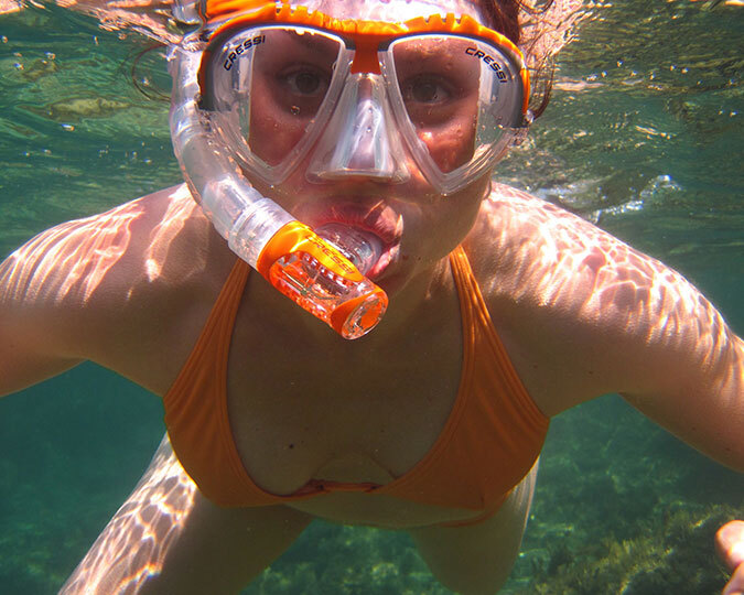 Breathing underwater with snorkel mask and tube